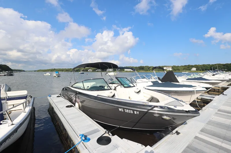 The Image of 2014 Monterey 268SS Super Sport boat docked at a marina under a blue sky. - 0