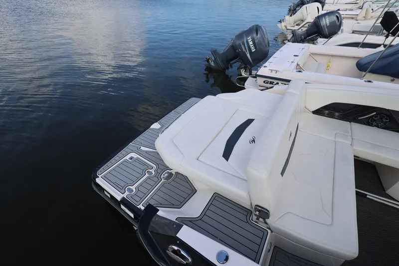 Slide: The Image of 2014 Monterey 268SS Super Sport boat docked on calm water, featuring sleek seating and swim platform. - 5