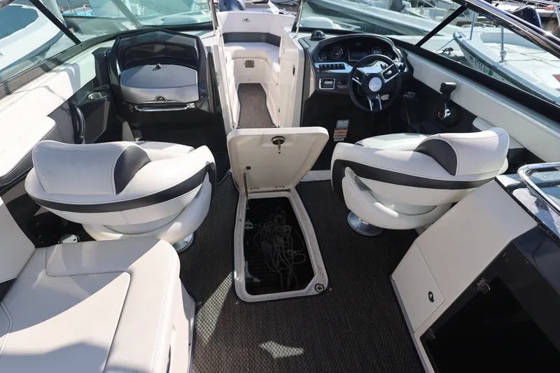 Slide: The Image of Interior of a 2014 Monterey 268SS Super Sport boat with seating and steering wheel. - 29