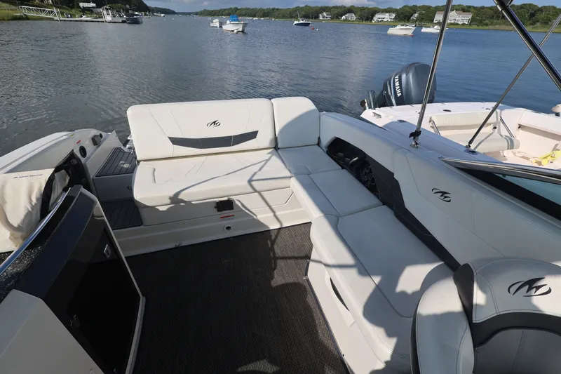 Slide: The Image of 2014 Monterey 268SS Super Sport boat interior with white seating on a calm lake. - 27