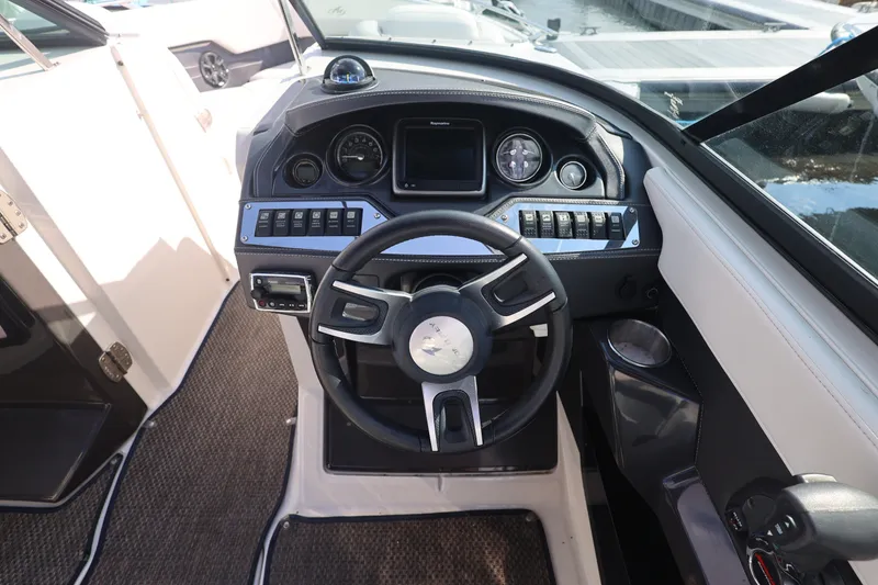 Slide: The Image of 2014 Monterey 268SS Super Sport boat dashboard with steering wheel and control panel. - 21
