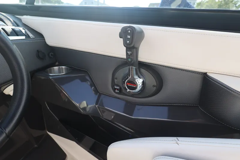 Slide: The Image of Interior of 2014 Monterey 268SS Super Sport boat with throttle control and cup holder. - 22