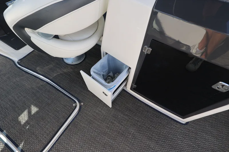 Slide: The Image of A trash bin is integrated into a cabinet on a boat, next to a cushioned seat. - 19
