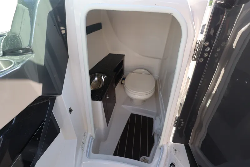 Slide: The Image of Interior of 2014 Monterey 268SS Super Sport boat bathroom with toilet and sink. - 31