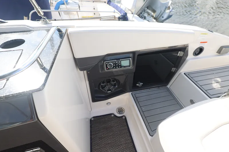 Slide: The Image of Interior of a 2014 Monterey 268SS Super Sport boat with audio system and storage. - 15