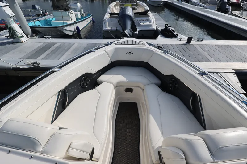 Slide: The Image of 2014 Monterey 268SS Super Sport boat interior with white seating at dock. - 35