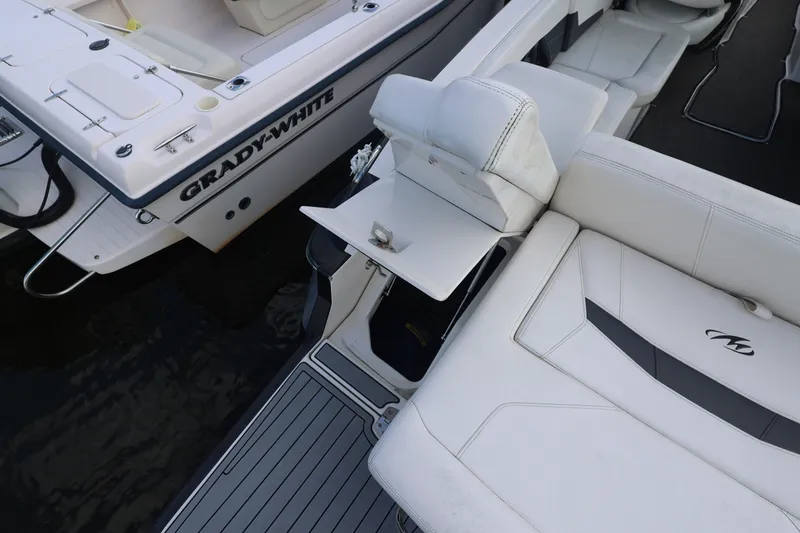 Slide: The Image of A 2014 Monterey 268SS Super Sport with white upholstery, next to a Grady-White boat. - 9