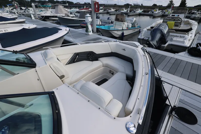 Slide: The Image of 2014 Monterey 268SS Super Sport boat docked at marina with white seating. - 4