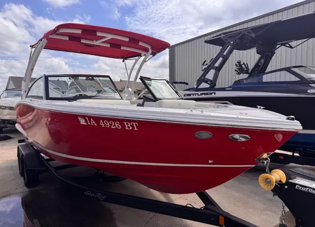 Slide: The Image of A red 2019 Cobalt CS23 boat on a trailer, ready for the water. - 2