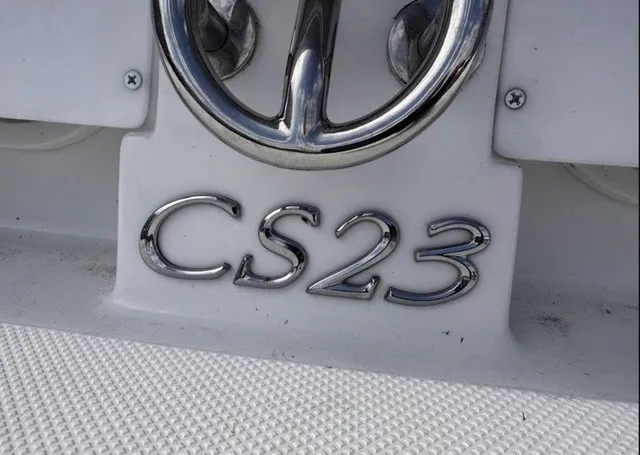 Slide: The Image of Close-up of the Cobalt CS23 emblem on a white boat. - 12