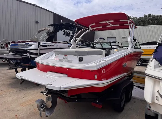 Slide: The Image of A red 2019 Cobalt CS23 boat on a trailer in a storage area. - 5