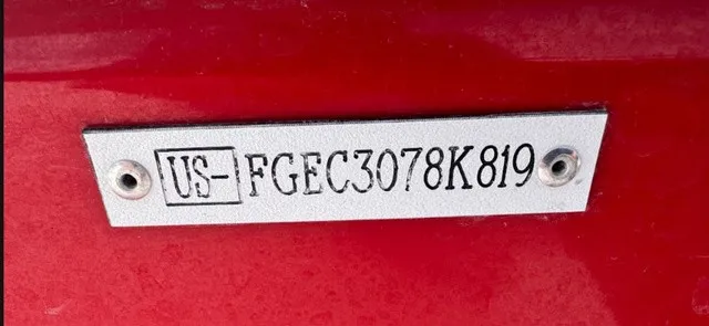 Slide: The Image of Close-up of a serial number on a red boat hull. - 15