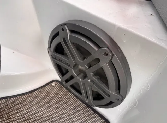 Slide: The Image of A speaker is integrated into the white interior paneling of a 2019 Cobalt CS23 boat. - 11