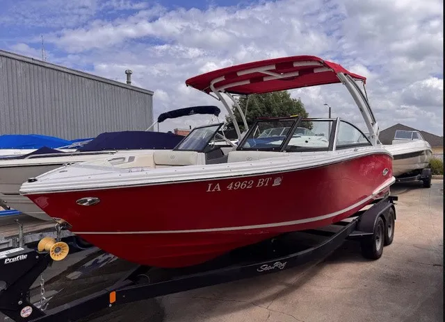 Slide: The Image of A red 2019 Cobalt CS23 boat is on a trailer in a marina area. - 3