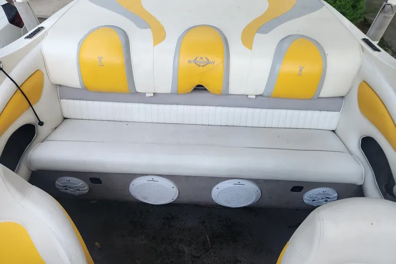 Slide: The Image of 2008 Stingray 185 LS/LX boat interior with yellow and white seating and built-in speakers. - 7