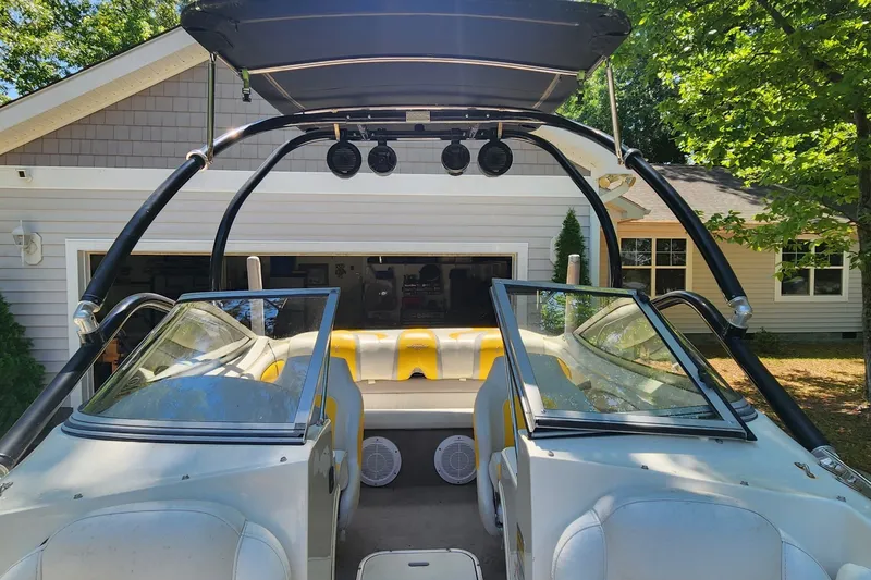 Slide: The Image of 2008 Stingray 185 LS/LX boat with open cockpit, parked near a garage. - 3
