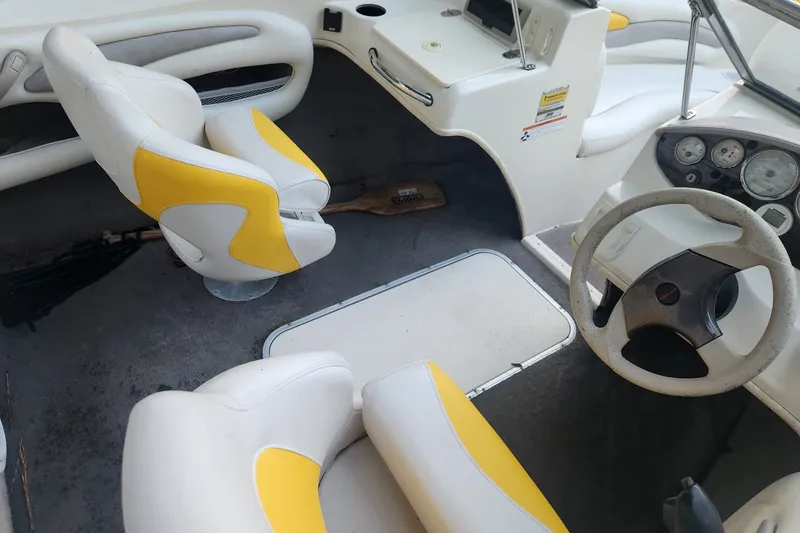 Slide: The Image of 2008 Stingray 185 LS/LX boat interior with yellow and white seating, steering wheel, and dashboard. - 6