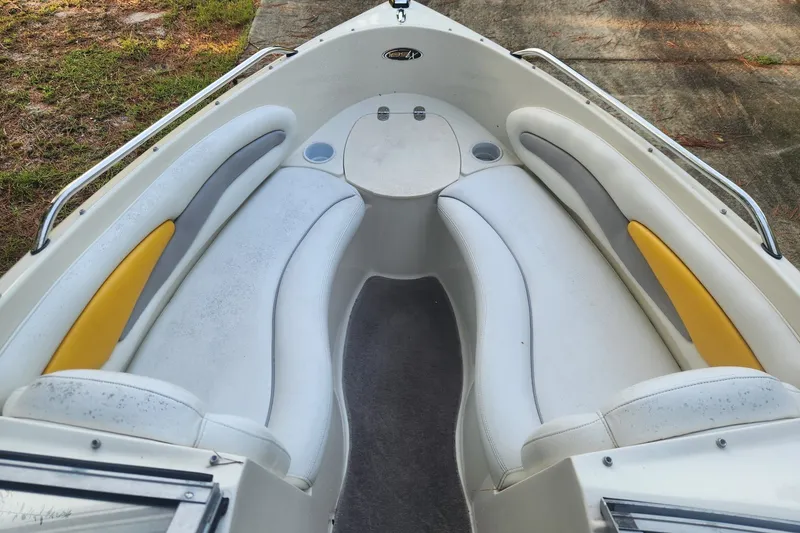 Slide: The Image of 2008 Stingray 185 LS/LX boat interior with white and yellow seating. - 2