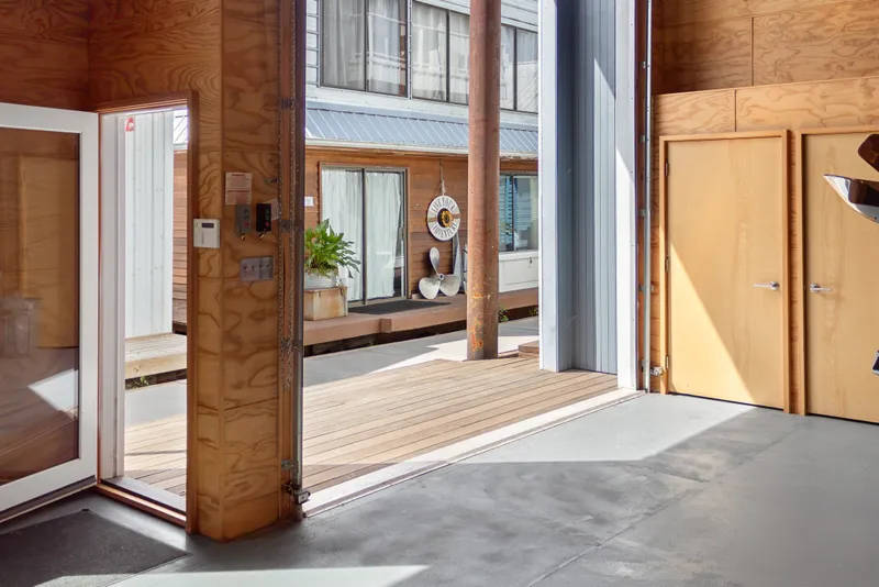 Slide: The Image of Interior of a 1969 Custom All Steel Boathouse with wooden doors and open entryway. - 16