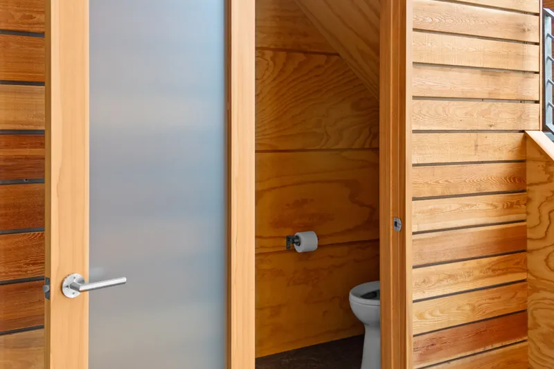 Slide: The Image of Wood-paneled bathroom with frosted glass door in a 1969 Custom All Steel Boathouse. - 38