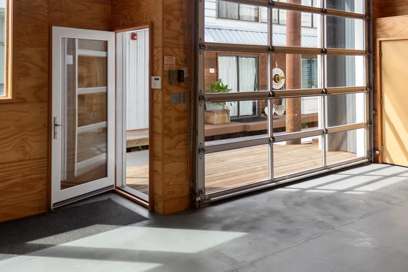 Slide: The Image of Interior of a 1969 Custom All Steel Boathouse with glass doors and wooden walls. - 22