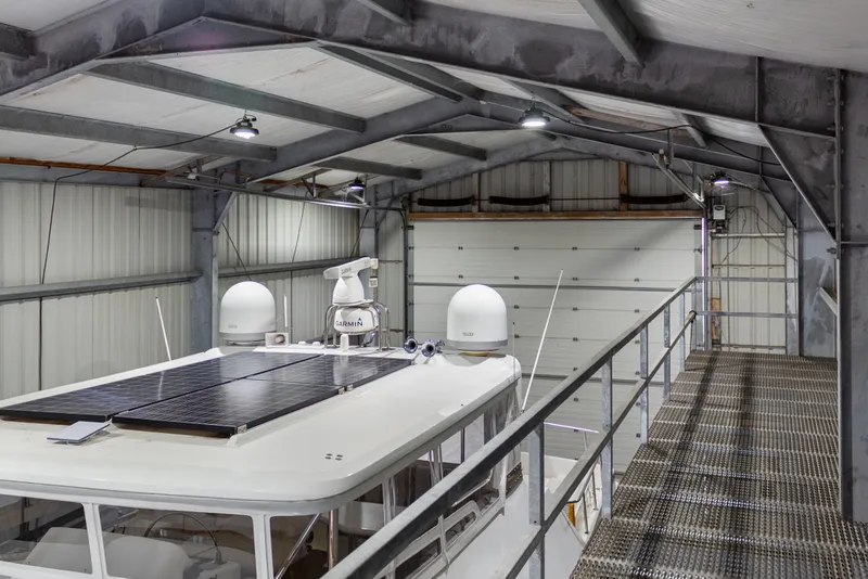 Slide: The Image of Interior of a 1969 Custom All Steel Boathouse with boat and solar panels. - 48