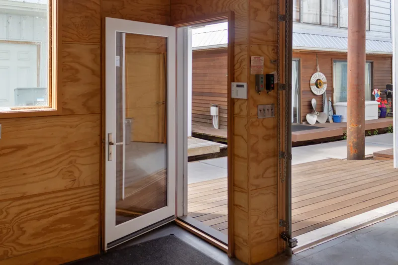 Slide: The Image of Interior view of a 1969 Custom All Steel Boathouse with open glass door. - 21