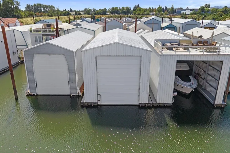 Slide: The Image of Custom All Steel Boathouse, 2008 model, with docked boat and rooftop seating area. - 3