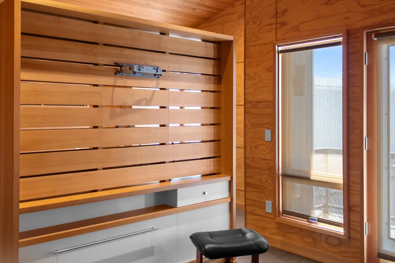 Slide: The Image of Interior of a 1969 Custom All Steel Boathouse with wooden paneling and modern design. - 70