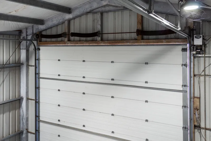 Slide: The Image of Interior view of a 1969 Custom All Steel Boathouse garage door mechanism. - 50