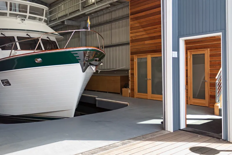 Slide: The Image of Custom All Steel Boathouse, 1969, housing a yacht with wooden interior accents. - 10