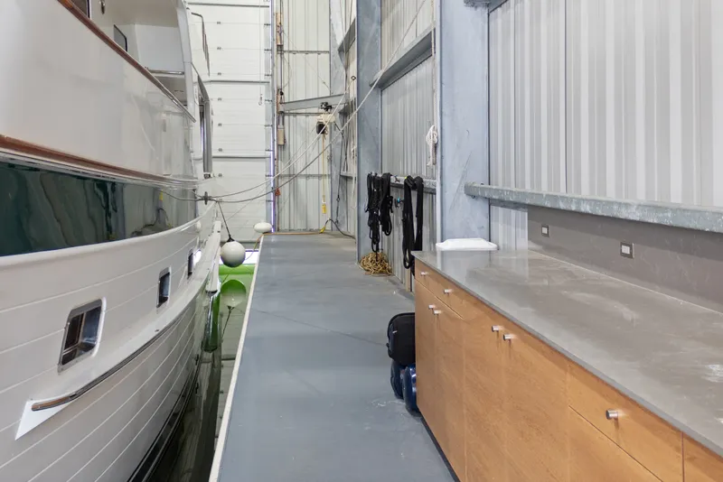 Slide: The Image of Custom All Steel Boathouse interior with docked boat and storage cabinets, 1969 design. - 23