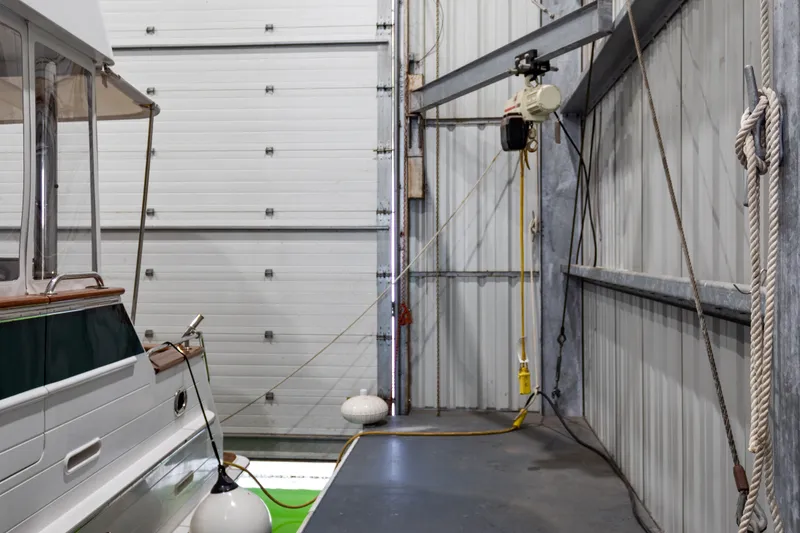 Slide: The Image of Interior of a 1969 Custom All Steel Boathouse with boat and hoist system. - 24