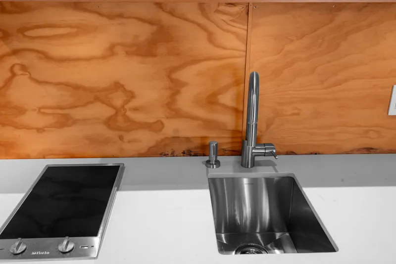 Slide: The Image of Modern kitchen sink and stovetop in 1969 Custom All Steel Boathouse with wooden backsplash. - 67