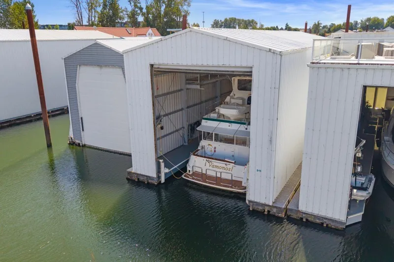 Slide: The Image of Custom All Steel Boathouse with yacht docked inside, built in 2008, on calm water. - 1