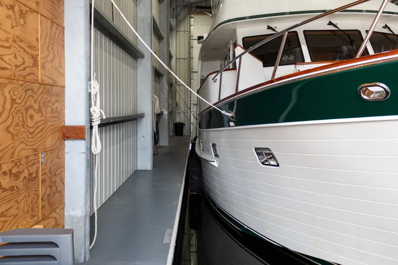 Slide: The Image of Custom All Steel Boathouse from 1969 with a docked boat inside. - 9