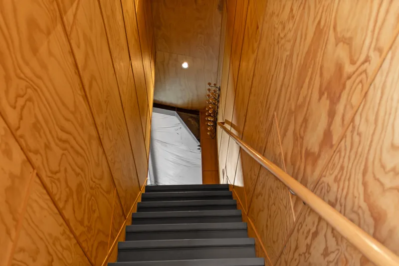 Slide: The Image of Wood-paneled staircase in 1969 Custom All Steel Boathouse, featuring modern design elements. - 44