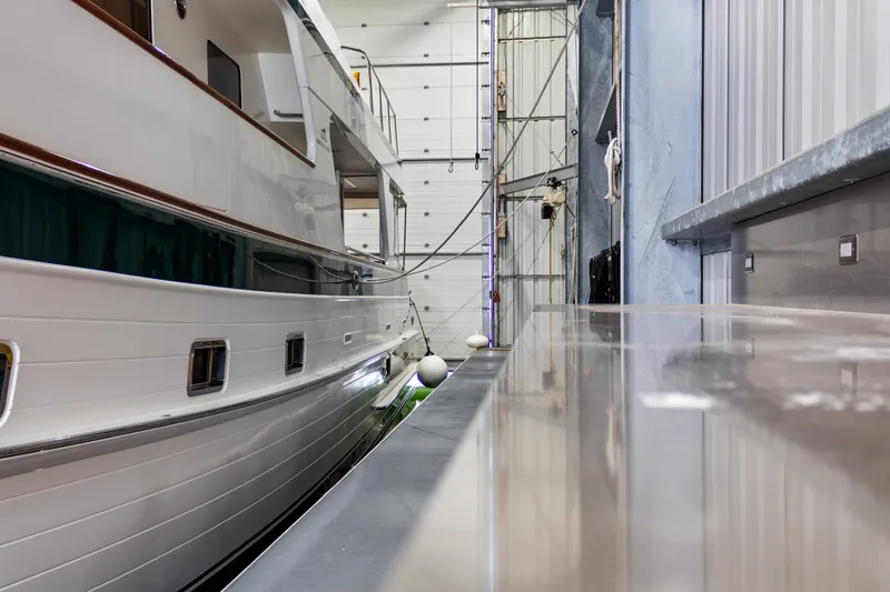 Slide: The Image of Custom All Steel Boathouse interior with docked boat, showcasing sleek design, 1969. - 30