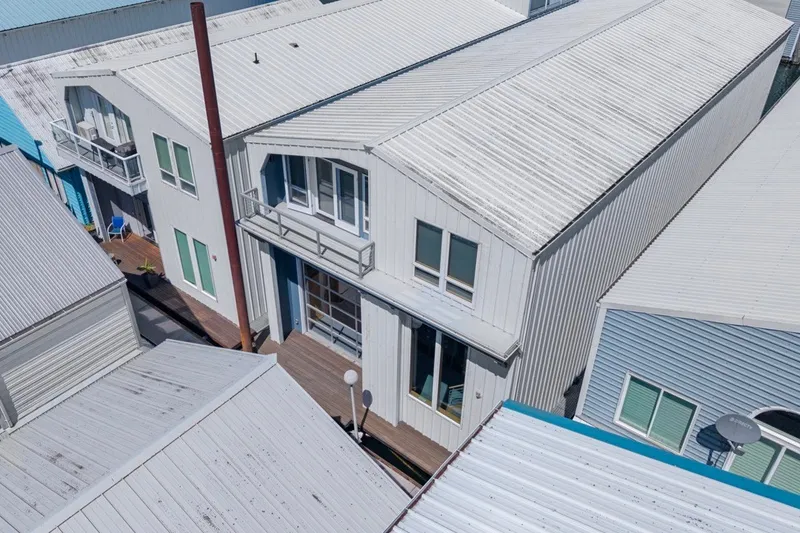 Slide: The Image of Aerial view of a 2008 Custom All Steel Boathouse with modern design and metal roofing. - 4
