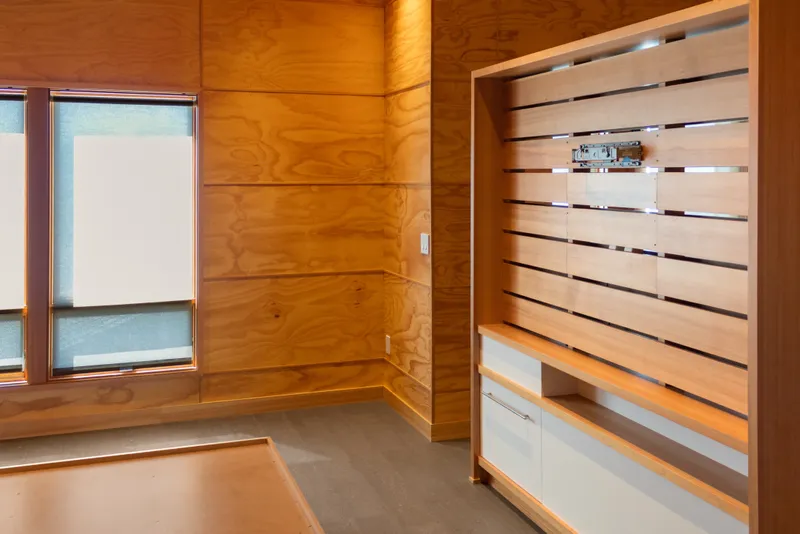Slide: The Image of Interior of a 1969 Custom All Steel Boathouse with wooden paneling and built-in shelving. - 58