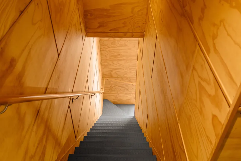 Slide: The Image of Wood-paneled staircase with blue steps in a 1969 Custom All Steel Boathouse. - 46