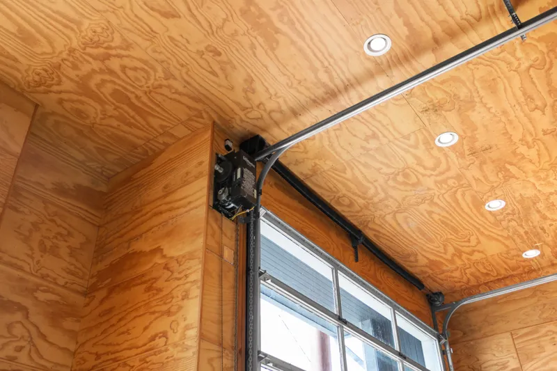 Slide: The Image of Interior view of a 1969 Custom All Steel Boathouse with wooden ceiling and garage door mechanism. - 42