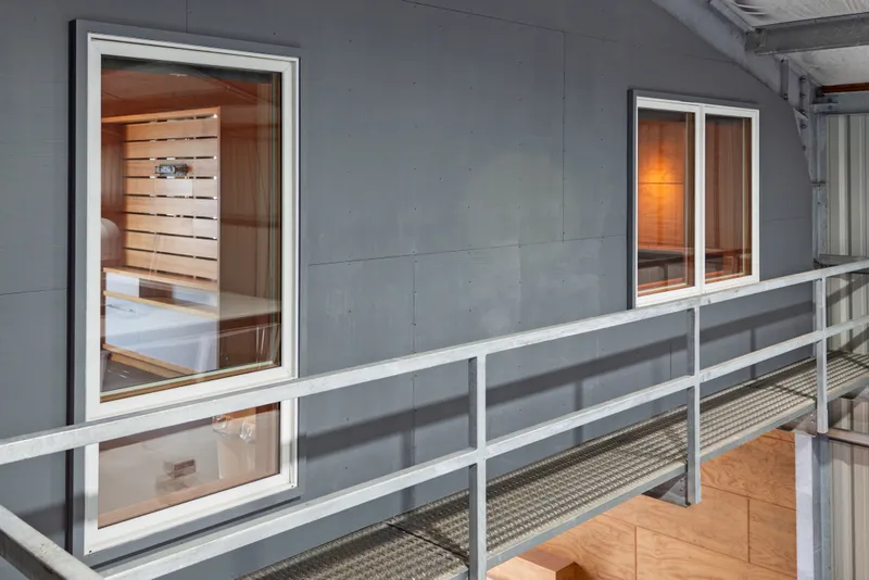 Slide: The Image of Exterior view of a 1969 Custom All Steel Boathouse with windows and metal walkway. - 51
