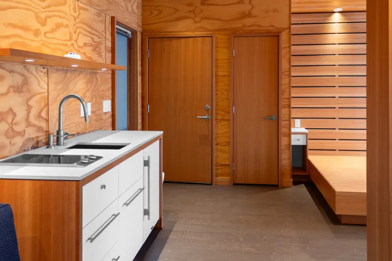 Slide: The Image of Modern wooden interior of a 1969 Custom All Steel Boathouse with sleek kitchen design. - 69