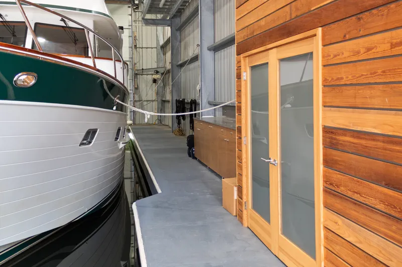 Slide: The Image of Custom All Steel Boathouse interior with docked boat and wooden door, 1969 design. - 18