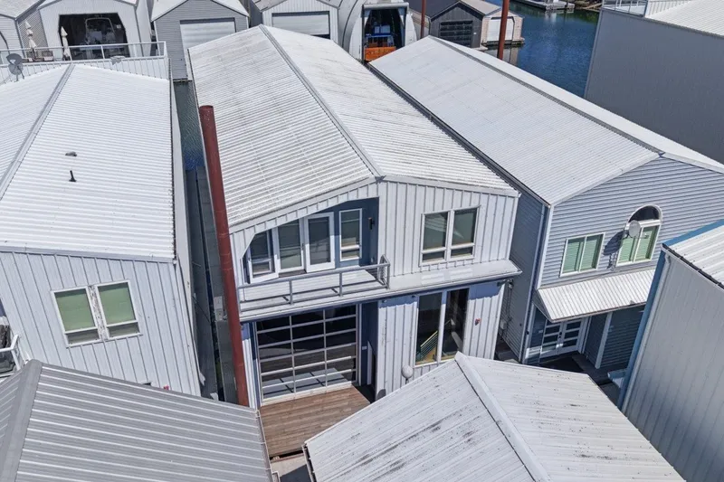 Slide: The Image of Aerial view of a 2008 Custom All Steel Boathouse with white metal roofing. - 5