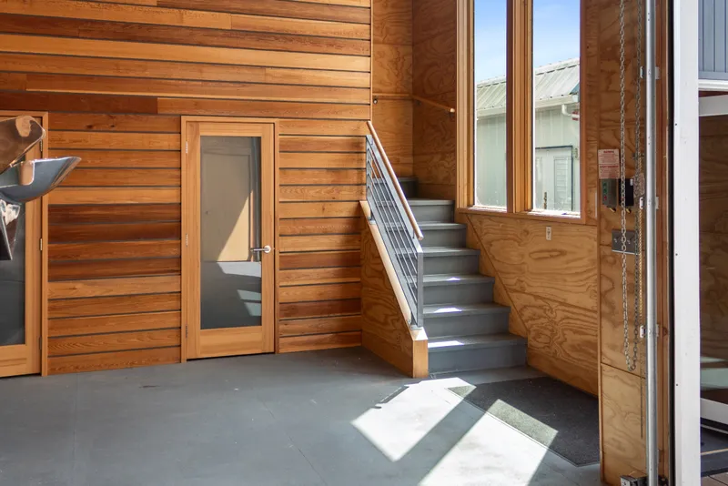 Slide: The Image of Interior of a 1969 Custom All Steel Boathouse with wooden walls and staircase. - 15