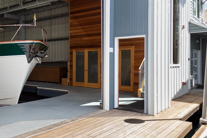 Slide: The Image of Custom All Steel Boathouse from 1969 with wooden interior and docked boat. - 12
