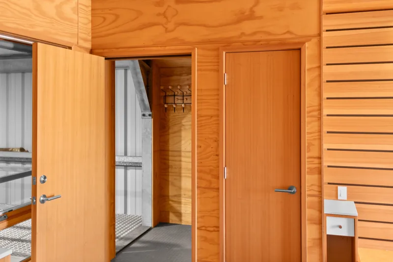 Slide: The Image of Interior of a 1969 Custom All Steel Boathouse with wooden doors and walls. - 56