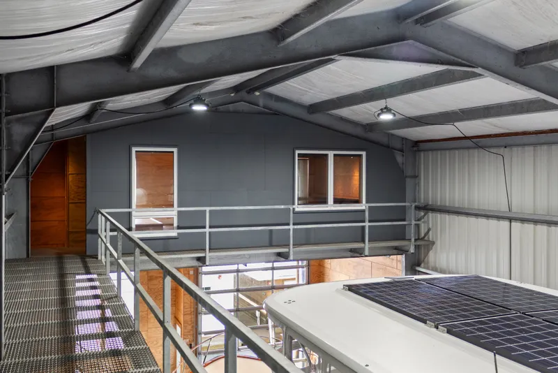 Slide: The Image of Interior of a 1969 custom all-steel boathouse with metal walkways and modern design. - 49